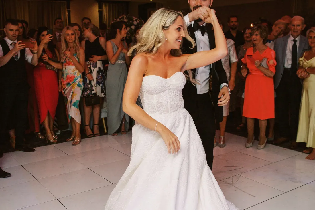 A bride dancing on a packed wedding floor